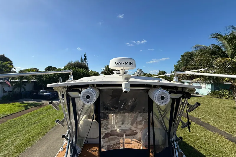 Slide: The Image of 2007 Grady-White Express 305 boat kitchen with appliances and wooden cabinets. - 27