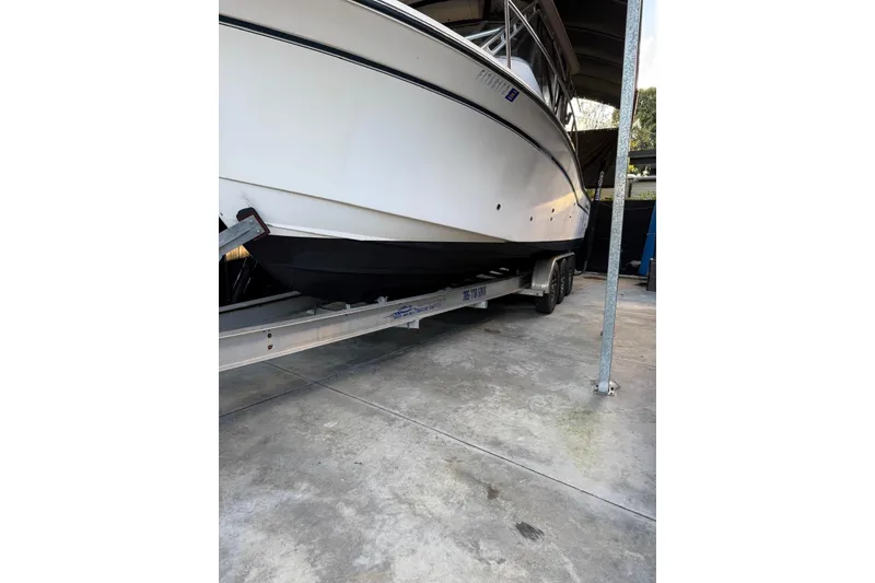 Slide: The Image of 2007 Grady-White Express 305 boat with twin Yamaha engines on a trailer. - 39