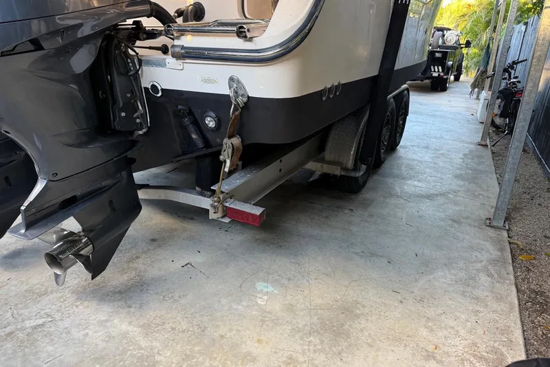 Slide: The Image of 2007 Grady-White Express 305 boat on trailer, parked in a covered area. - 44