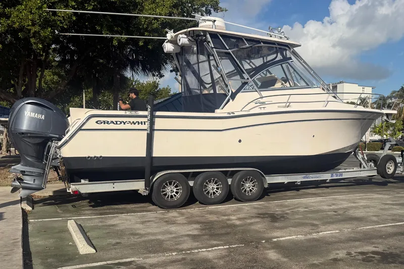 Slide: The Image of 2007 Grady-White Express 305 boat on trailer with Yamaha engine in parking lot. - 47