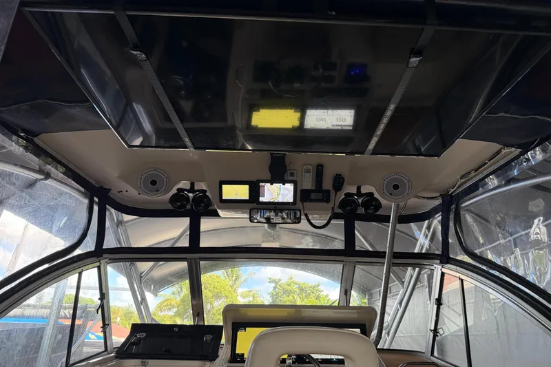 Slide: The Image of 2007 Grady-White Express 305 boat storage compartment with open lid, showing equipment inside. - 5