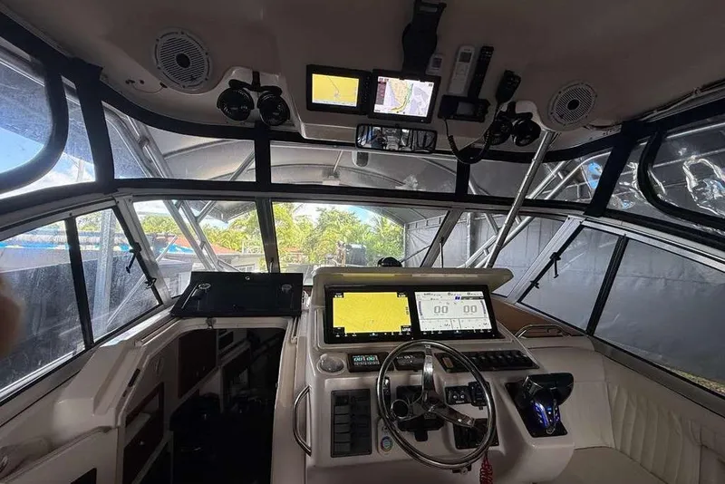 Slide: The Image of 2007 Grady-White Express 305 boat interior with cushioned seating and teak flooring. - 6