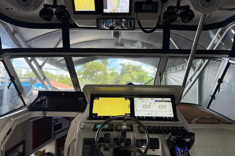 Slide: The Image of 2007 Grady-White Express 305 boat interior with cushioned seating and teak flooring. - 7