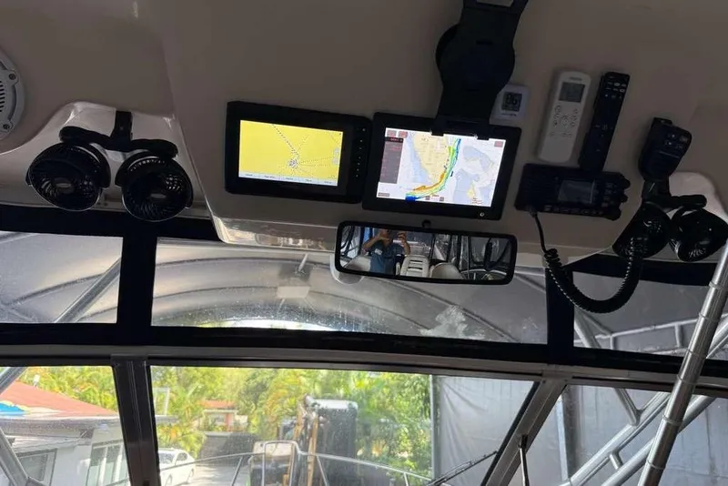 Slide: The Image of Open storage compartment on 2007 Grady-White Express 305 boat, featuring teak flooring. - 9