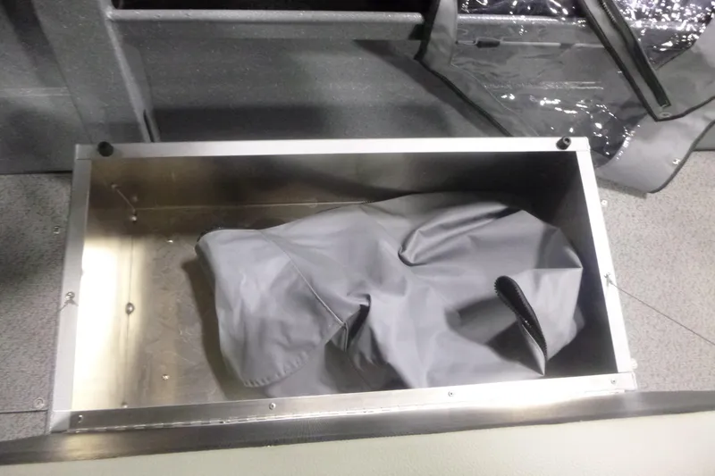 Slide: The Image of Storage compartment in KingFisher 2025 Falcon boat, featuring a gray cover. - 26