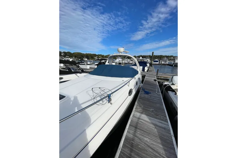 Slide: The Image of 2003 Sea Ray 280 Sundancer docked at marina under blue sky. - 2