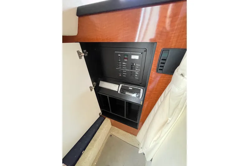 Slide: The Image of Control panel inside 2003 Sea Ray 280 Sundancer boat cabin with wood finish. - 20