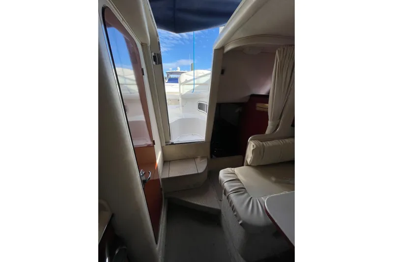 Slide: The Image of Interior view of 2003 Sea Ray 280 Sundancer cabin with seating and doorway. - 21