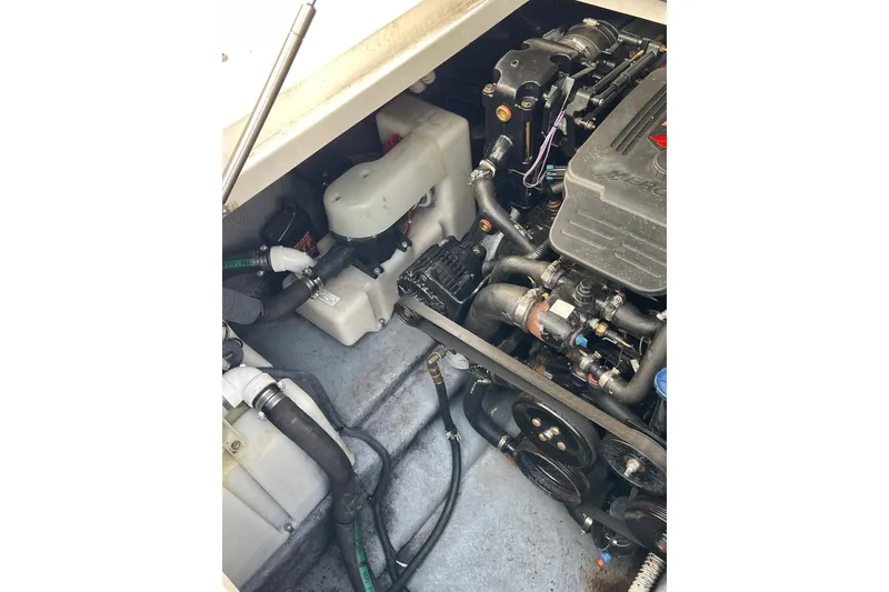Slide: The Image of Engine compartment of a 2003 Sea Ray 280 Sundancer boat, showcasing mechanical components. - 22