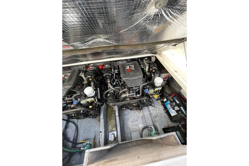 Slide: The Image of Engine compartment of a 2003 Sea Ray 280 Sundancer boat, showcasing dual engines. - 24