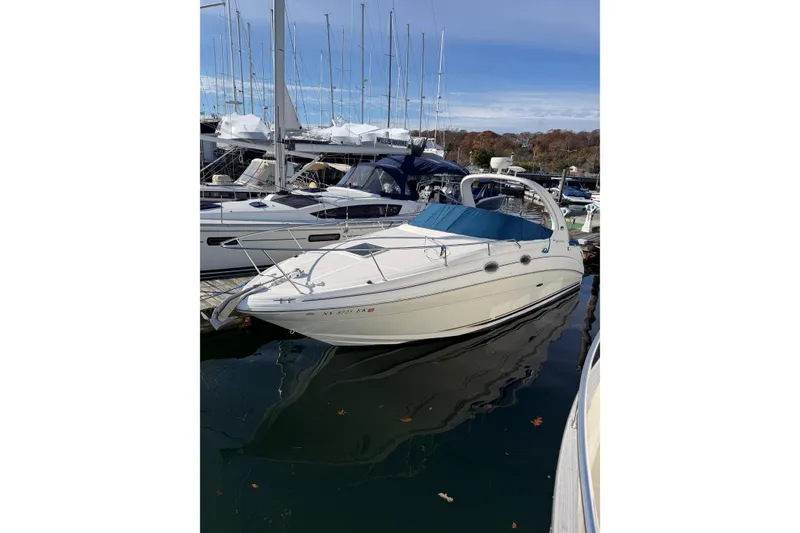 Slide: The Image of 2003 Sea Ray 280 Sundancer docked at marina, surrounded by sailboats. - 27