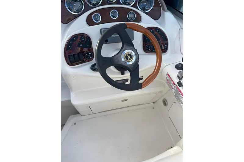 Slide: The Image of Steering wheel and dashboard of 2003 Sea Ray 280 Sundancer boat. - 5