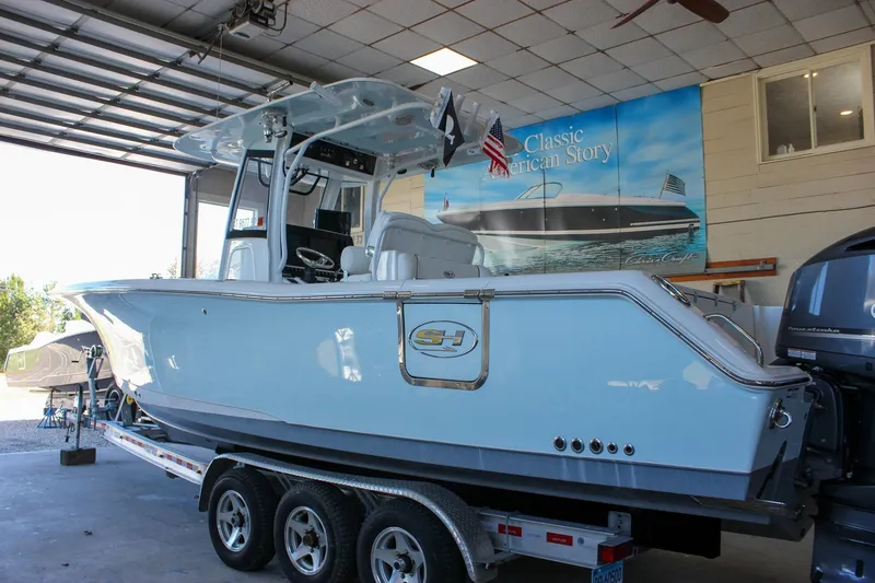 The Image of 2018 Sea Hunt Gamefish 30 boat on trailer in garage setting. - 0