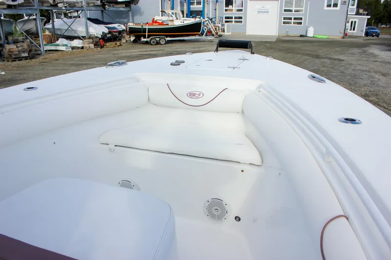 Slide: The Image of 2018 Sea Hunt Gamefish 30 boat interior with white seating and clean deck. - 14