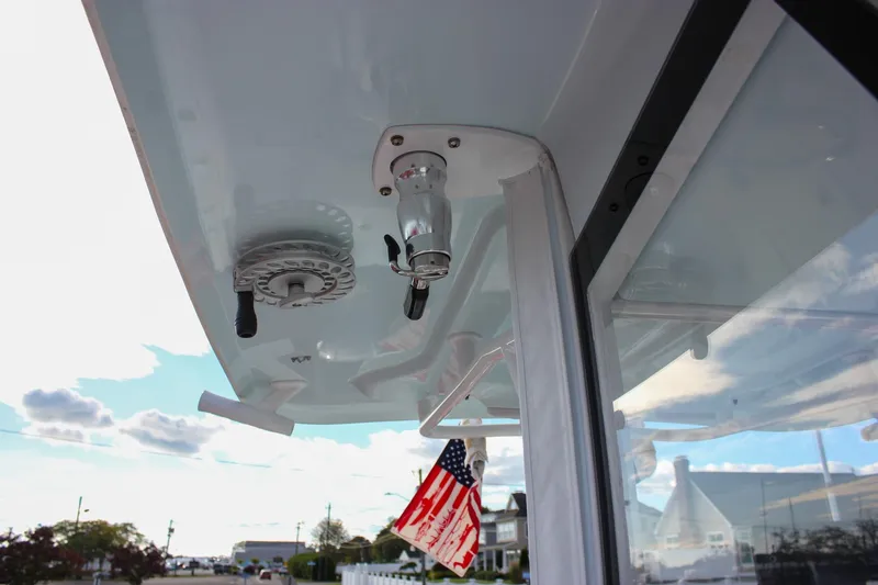 Slide: The Image of 2018 Sea Hunt Gamefish 30 boat detail with American flag and clear sky. - 19