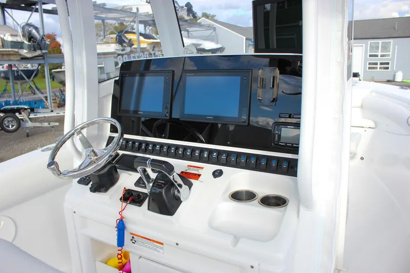 Slide: The Image of 2018 Sea Hunt Gamefish 30 helm with dual screens and modern controls. - 20