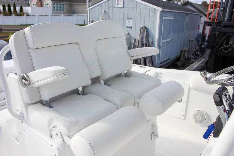Slide: The Image of 2018 Sea Hunt Gamefish 30 boat with white cushioned seating and armrests. - 26
