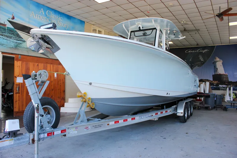 Slide: The Image of 2018 Sea Hunt Gamefish 30 boat on trailer in indoor showroom. - 3