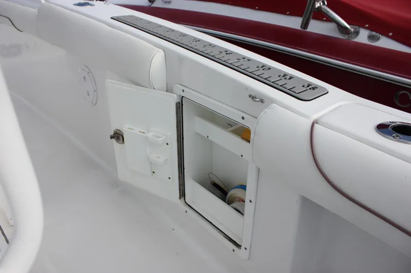 Slide: The Image of 2018 Sea Hunt Gamefish 30 boat interior with open storage compartment and measuring ruler. - 32