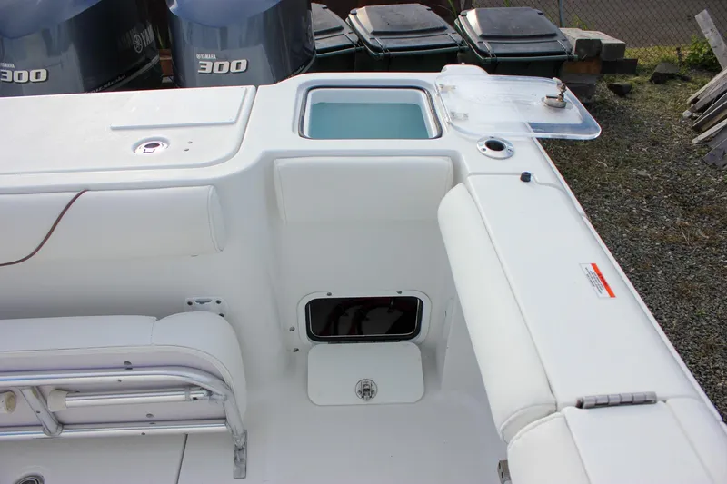 Slide: The Image of 2018 Sea Hunt Gamefish 30 boat interior with Yamaha 300 engines, featuring storage and seating. - 39