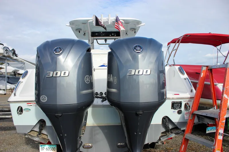 Slide: The Image of 2018 Sea Hunt Gamefish 30 with dual Yamaha 300 engines at a marina. - 4