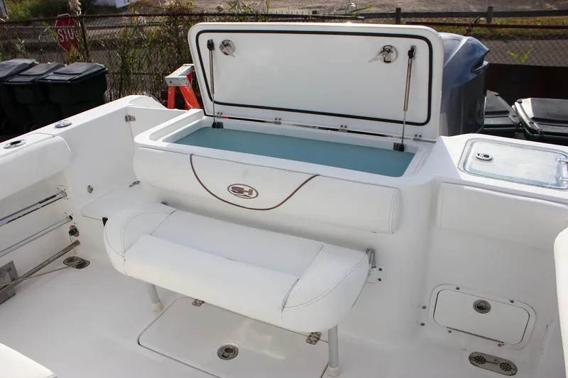 Slide: The Image of 2018 Sea Hunt Gamefish 30 boat interior with open storage compartment and seating. - 41