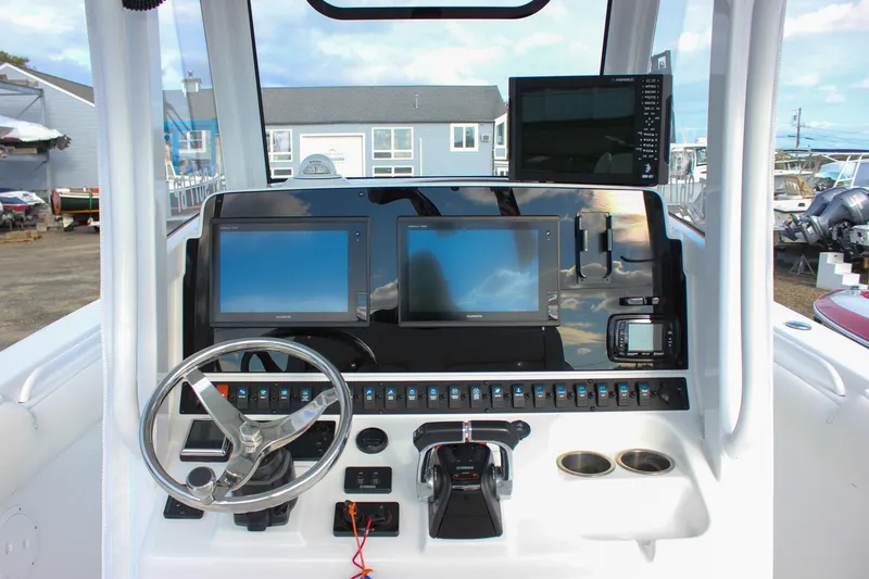 Slide: The Image of 2018 Sea Hunt Gamefish 30 helm with dual displays and modern controls. - 5