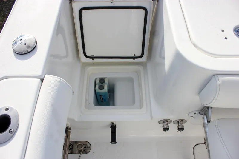 Slide: The Image of 2018 Sea Hunt Gamefish 30 boat storage compartment with cleaning supplies. - 52