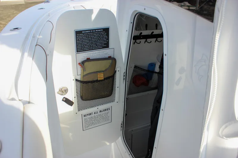 Slide: The Image of 2018 Sea Hunt Gamefish 30 boat interior storage compartment with safety instructions. - 53