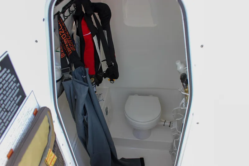 Slide: The Image of 2018 Sea Hunt Gamefish 30 boat interior with toilet and hanging gear. - 54