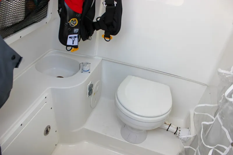 Slide: The Image of 2018 Sea Hunt Gamefish 30 boat interior with toilet and sink. - 56