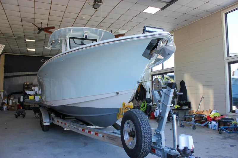 Slide: The Image of 2018 Sea Hunt Gamefish 30 boat on trailer in a garage setting. - 60
