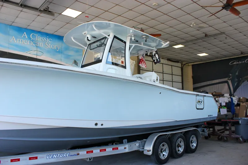Slide: The Image of 2018 Sea Hunt Gamefish 30 boat on trailer in indoor showroom. - 64