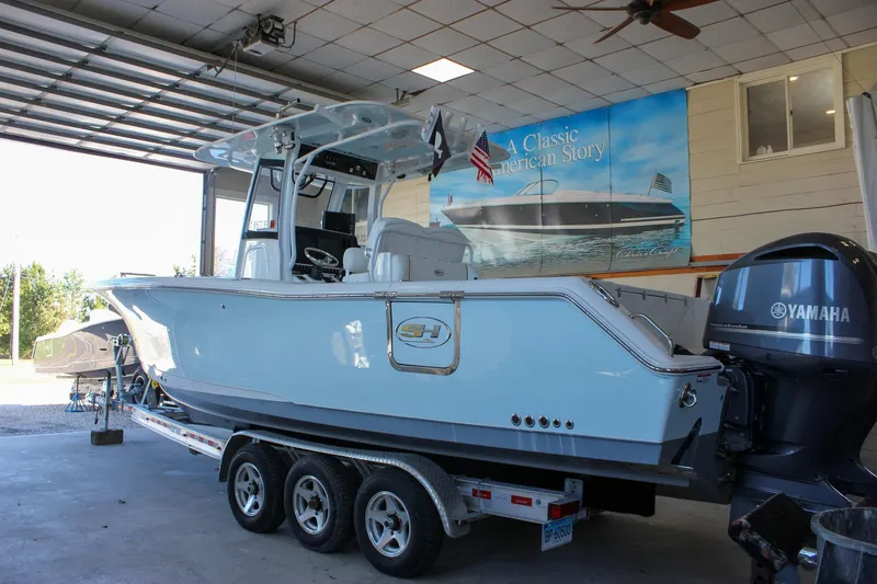 Slide: The Image of 2018 Sea Hunt Gamefish 30 boat in garage with Yamaha engine. - 65
