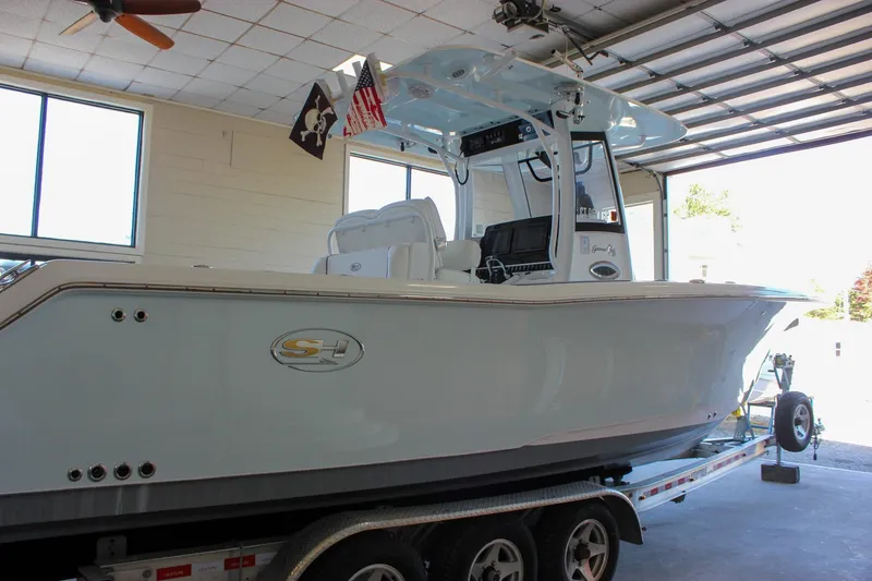 Slide: The Image of 2018 Sea Hunt Gamefish 30 boat on trailer in garage setting. - 68