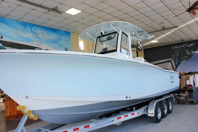 Slide: The Image of 2018 Sea Hunt Gamefish 30 boat on trailer in showroom. - 69