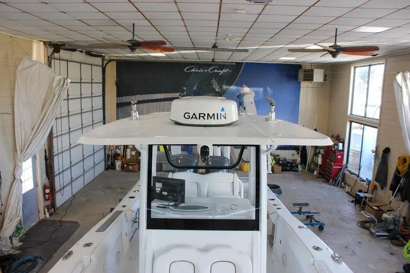 Slide: The Image of 2018 Sea Hunt Gamefish 30 boat in a garage with Garmin equipment. - 70