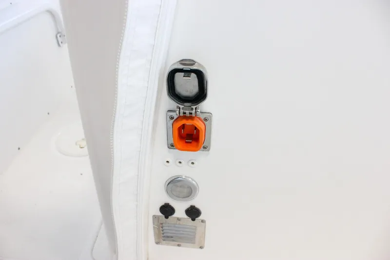 Slide: The Image of 2018 Sea Hunt Gamefish 30 boat electrical outlet and controls on white panel. - 73