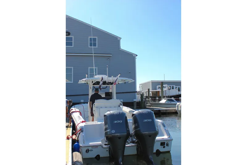 Slide: The Image of 2018 Sea Hunt Gamefish 30 boat covered on trailer in indoor showroom. - 74