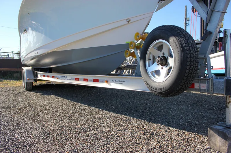 Slide: The Image of 2018 Sea Hunt Gamefish 30 on trailer, parked on gravel surface. - 79