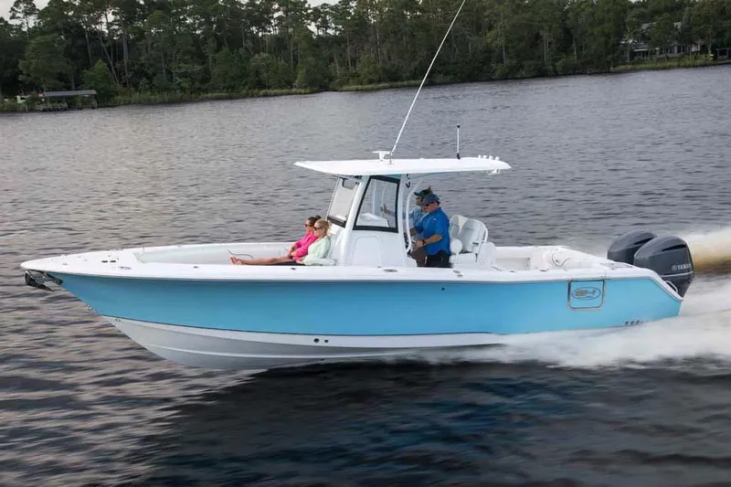 Slide: The Image of 2018 Sea Hunt Gamefish 30 boat covered in a protective tarp inside a workshop. - 83