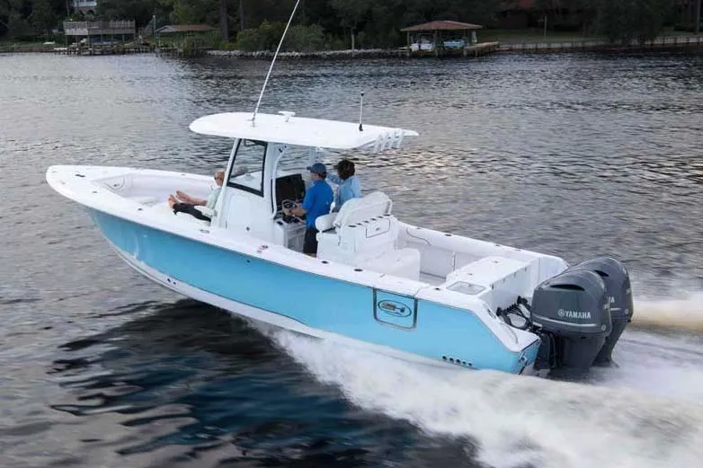 Slide: The Image of 2018 Sea Hunt Gamefish 30 boat covered in black tarp inside a garage. - 84
