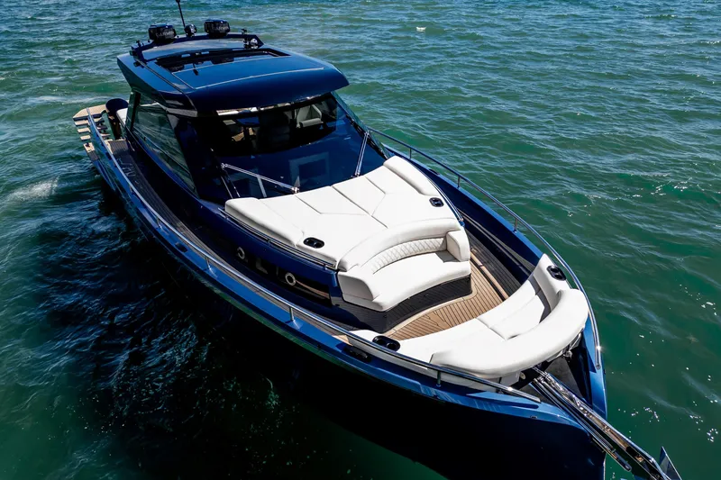 Slide: The Image of Luxurious 2025 Dutch American DA 53 yacht with elegant seating and American flag. - 13