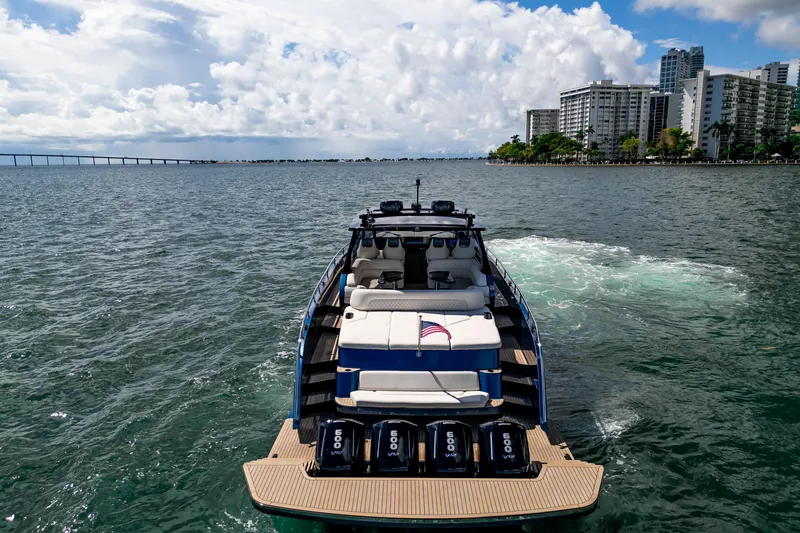 Slide: The Image of Luxurious 2025 Dutch American DA 53 yacht on a serene lake with elegant homes in the background. - 5