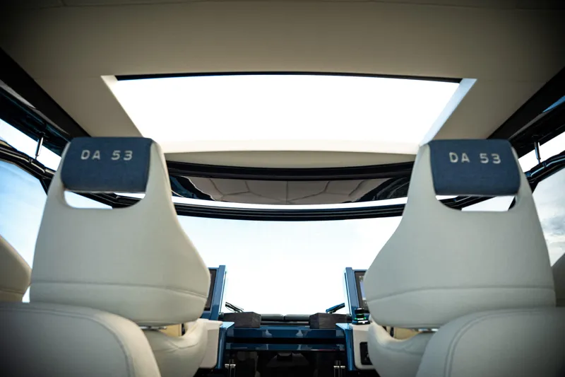 Slide: The Image of Luxurious 2025 Dutch American DA 53 yacht with plush seating on calm ocean waters. - 56