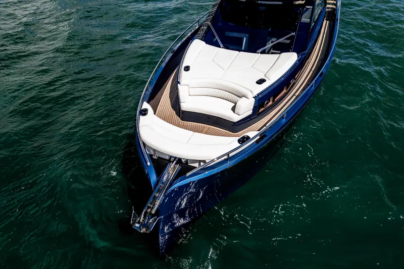 Slide: The Image of 2025 Dutch American DA 53 yacht with sleek blue exterior and wooden steps. - 9