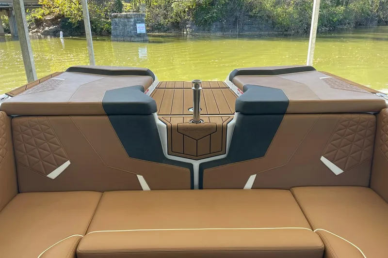 Slide: The Image of 2024 Nautique Super Air Nautique GS22 interior with brown seating and elegant design. - 10