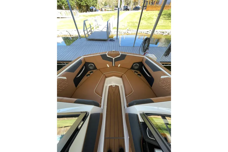 Slide: The Image of 2024 Nautique Super Air Nautique GS22 interior with tan seating and sleek design. - 12