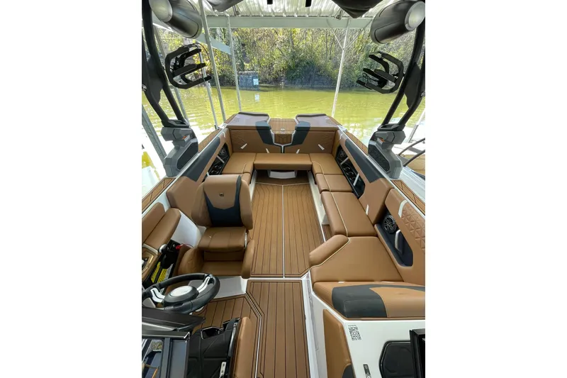 Slide: The Image of 2024 Nautique Super Air Nautique GS22 interior with tan seating and modern design. - 13