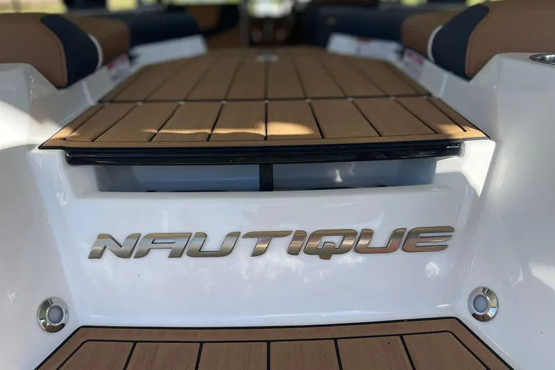 Slide: The Image of 2024 Nautique Super Air Nautique GS22 boat deck with logo and seating. - 17